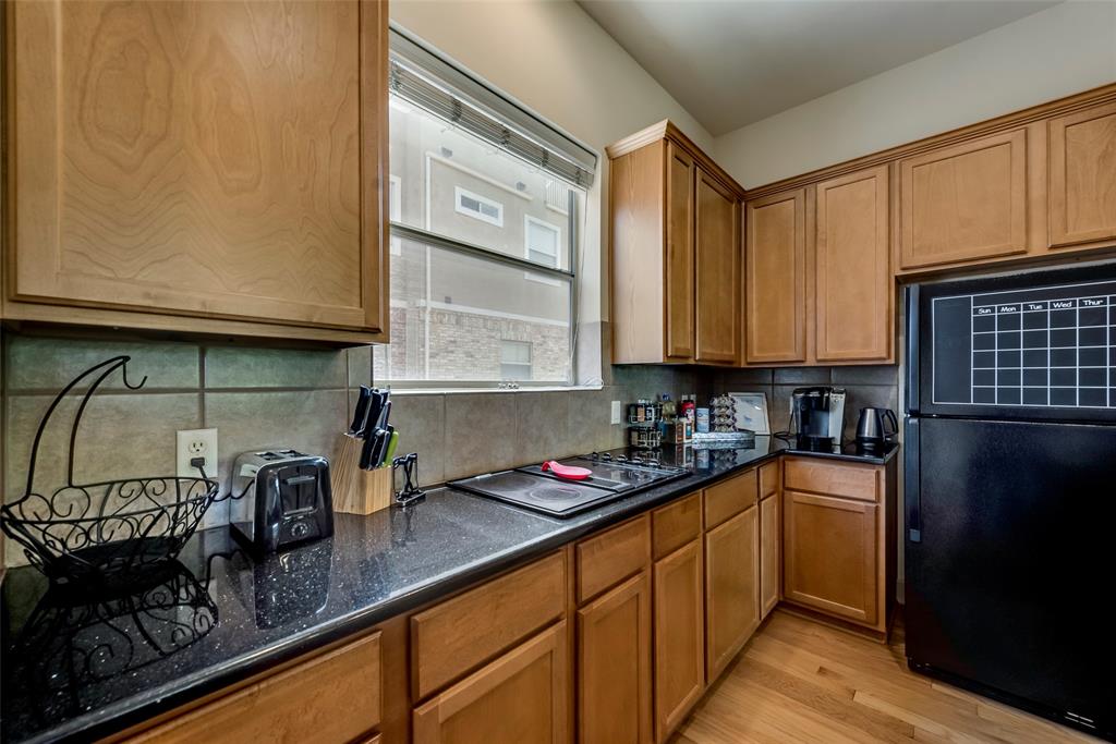 2718 Floyd Street Dallas, TX 75204 - Photo 14 of 25 a kitchen with granite countertop a sink a stove and cabinets
