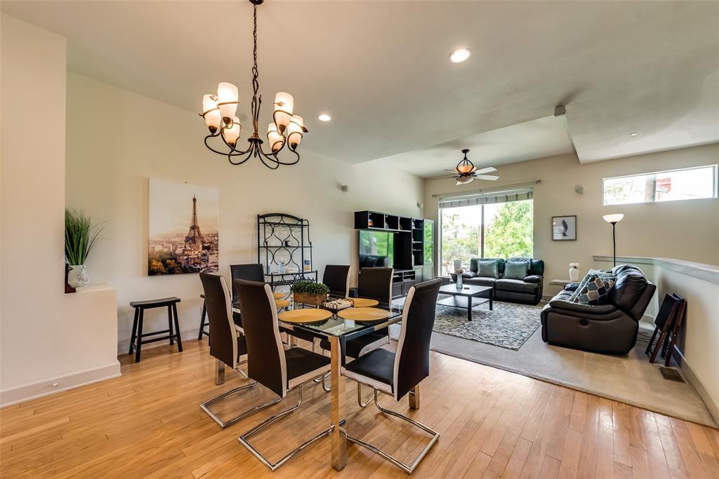 2718 Floyd Street Dallas, TX 75204 - Photo 22 of 25 a view of a dining room with furniture a chandelier and wooden floor