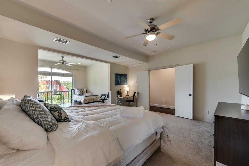 2718 Floyd Street Dallas, TX 75204 - Photo 7 of 25 a bed room with a bed and a chandelier