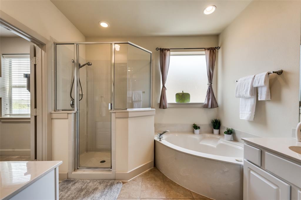 2718 Floyd Street Dallas, TX 75204 - Photo 9 of 25 a bathroom with a tub shower sink and mirror