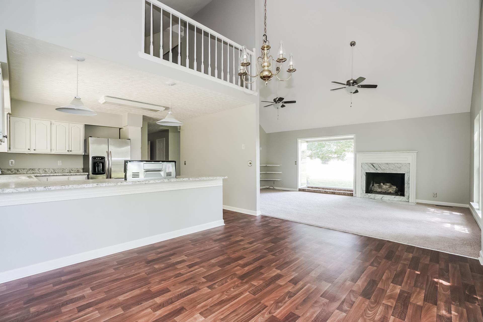 207 Independence Street Springfield, TN 37172 - Photo 12 of 25 a view of living room kitchen with a fireplace and wooden floor