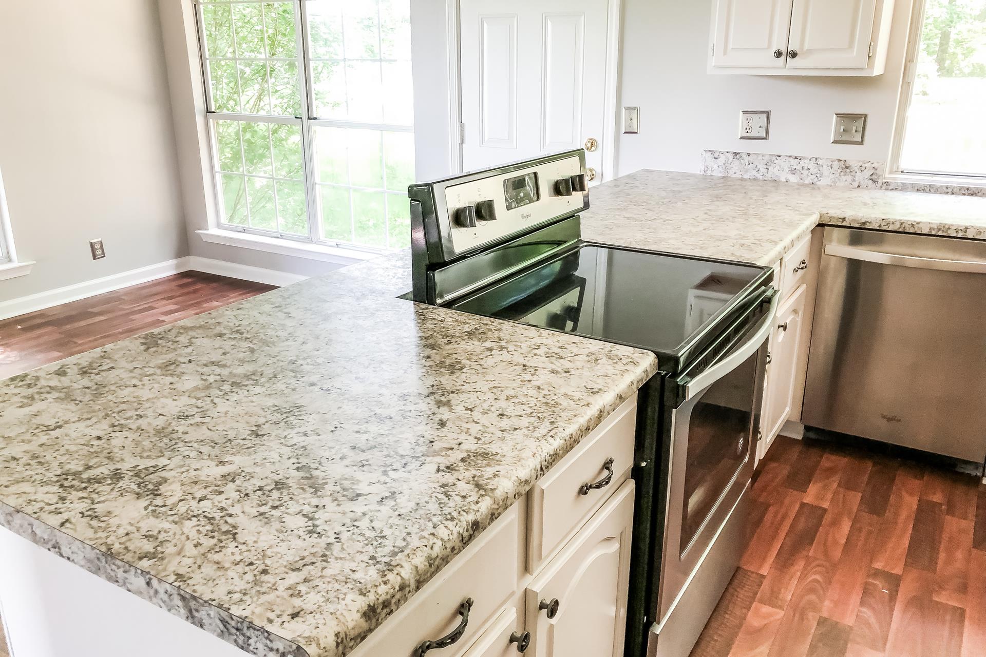207 Independence Street Springfield, TN 37172 - Photo 17 of 25 a kitchen with stainless steel appliances granite countertop a sink stove and oven