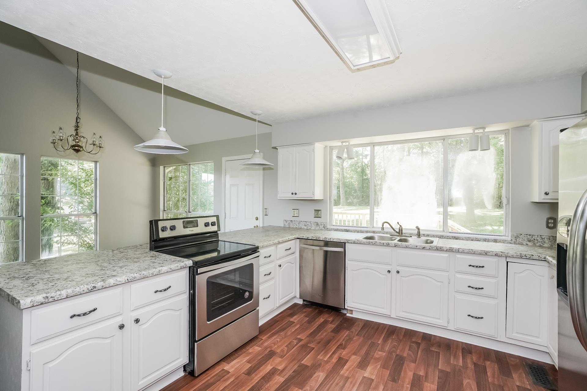 207 Independence Street Springfield, TN 37172 - Photo 2 of 25 a kitchen with a stove a sink and wooden floor