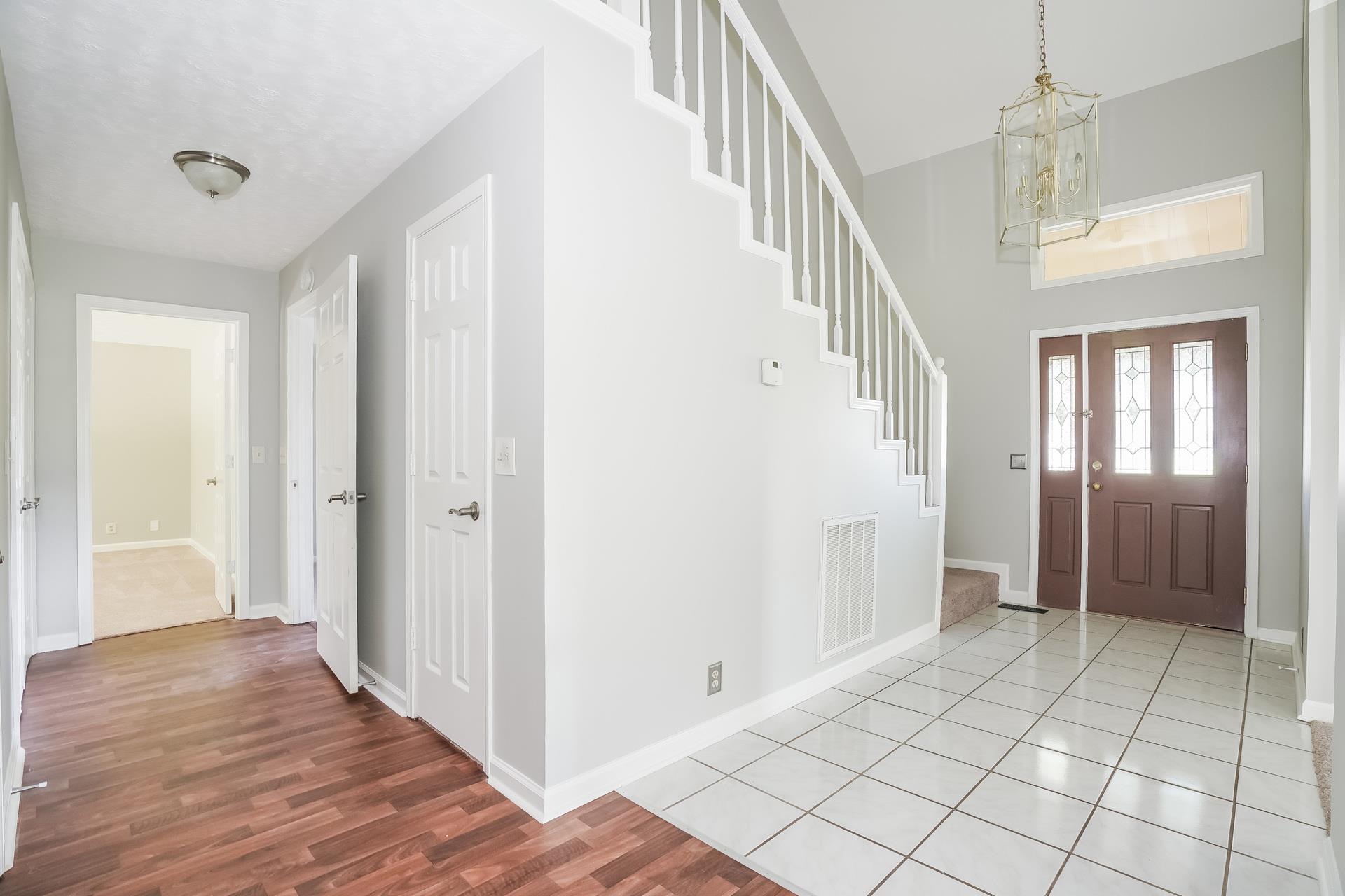 207 Independence Street Springfield, TN 37172 - Photo 7 of 25 a view of an entryway with wooden floor and staircase