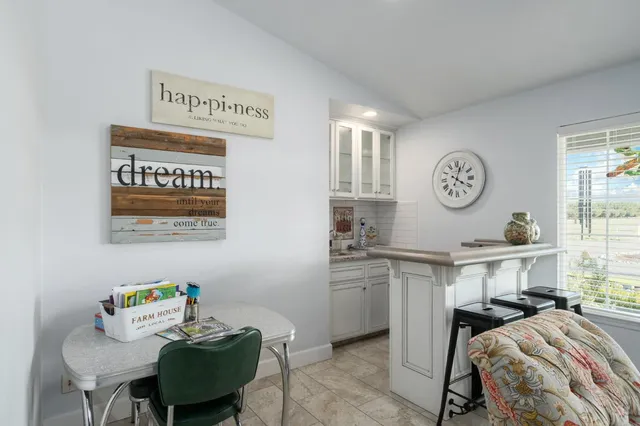 a view of a room that has a bed and a chair in it