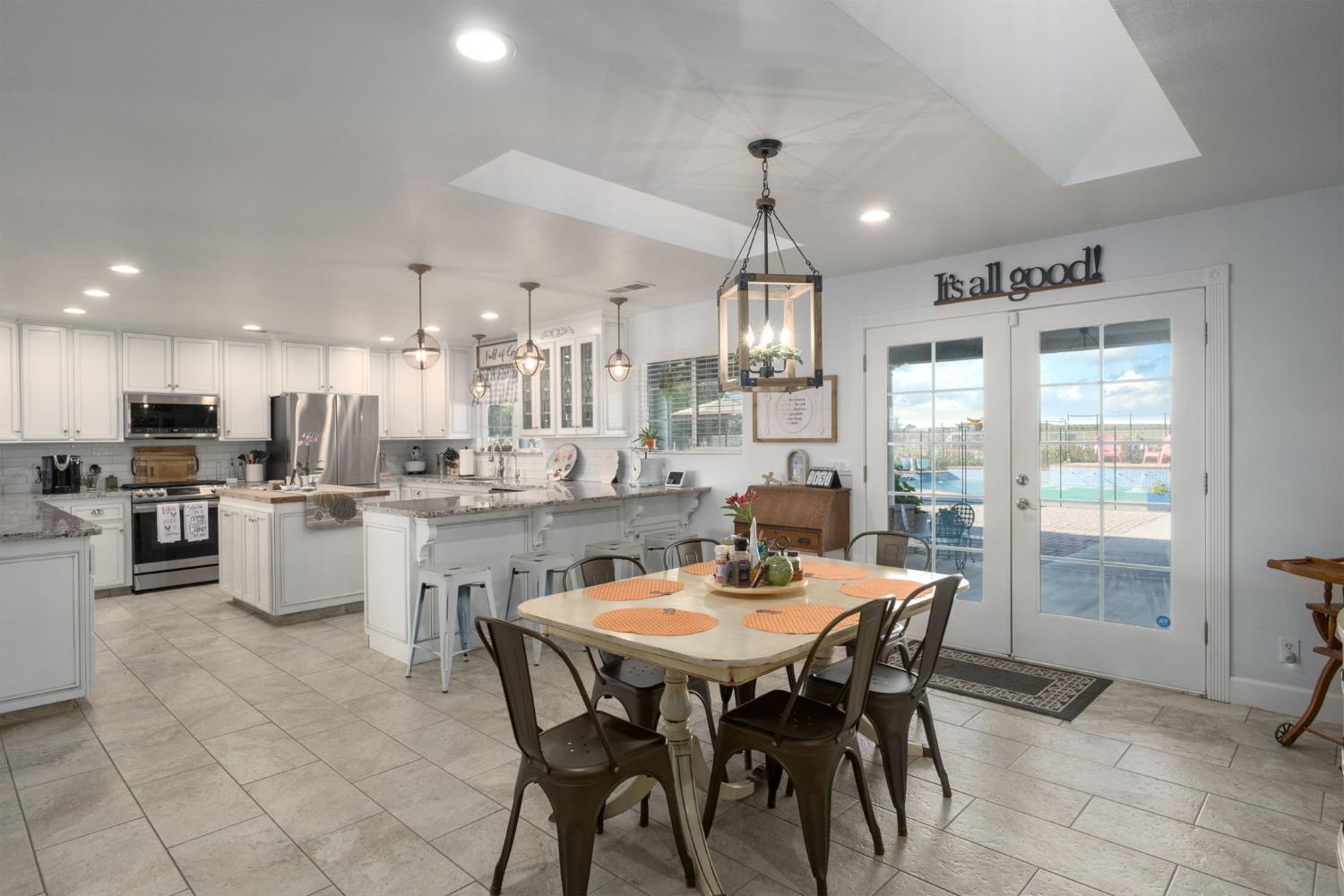 17534 West Lacey Boulevard Lemoore, CA 93245 - Photo 22 of 49 a large kitchen with a table and chairs