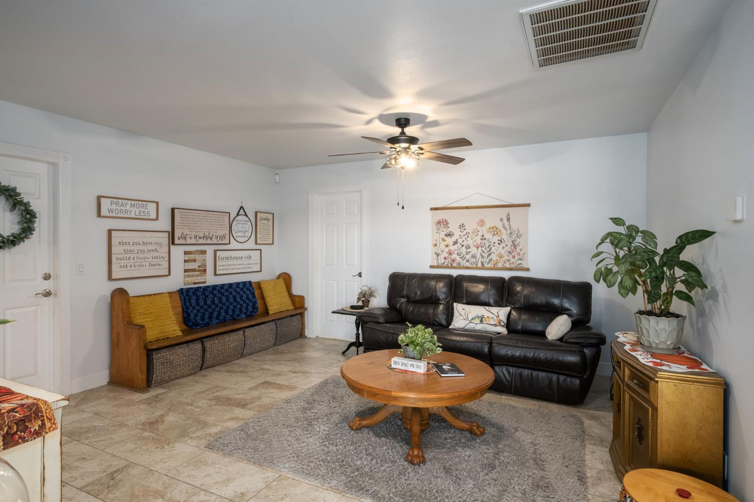 17534 West Lacey Boulevard Lemoore, CA 93245 - Photo 24 of 49 a living room with furniture and a potted plant