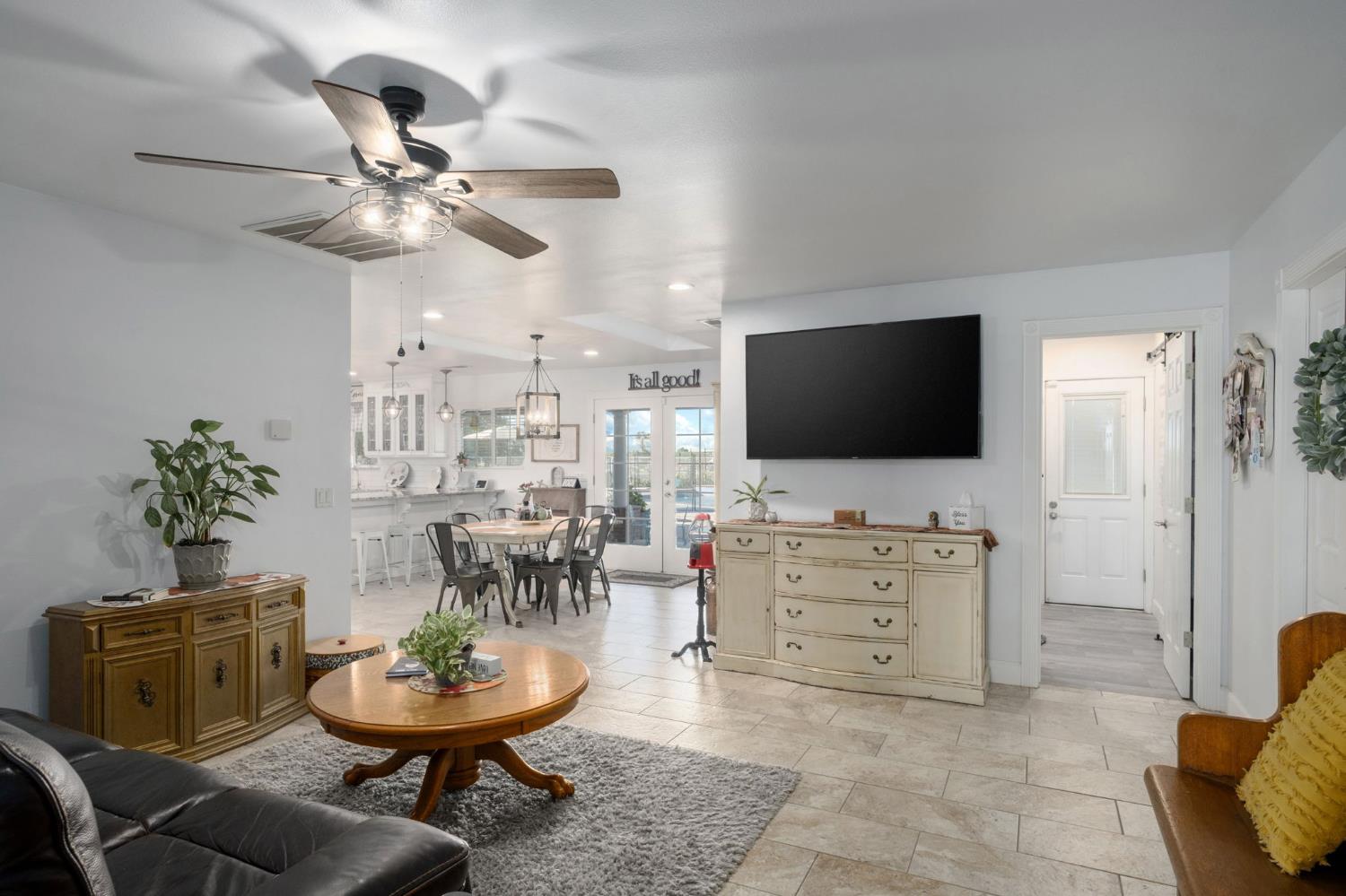 17534 West Lacey Boulevard Lemoore, CA 93245 - Photo 25 of 49 a living room with furniture and a flat screen tv