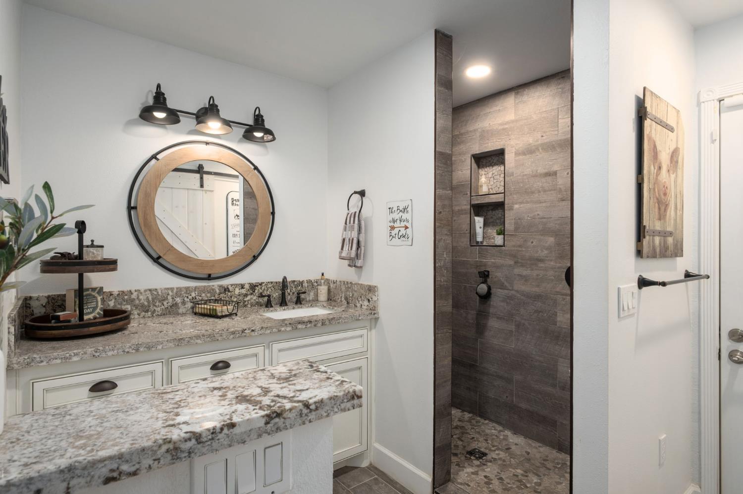 17534 West Lacey Boulevard Lemoore, CA 93245 - Photo 26 of 49 a bathroom with a granite countertop sink a mirror and shower