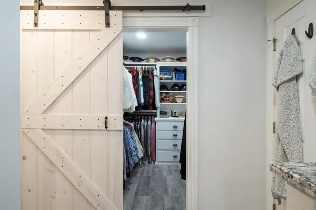 a view of walk in closet with clothes and shoes