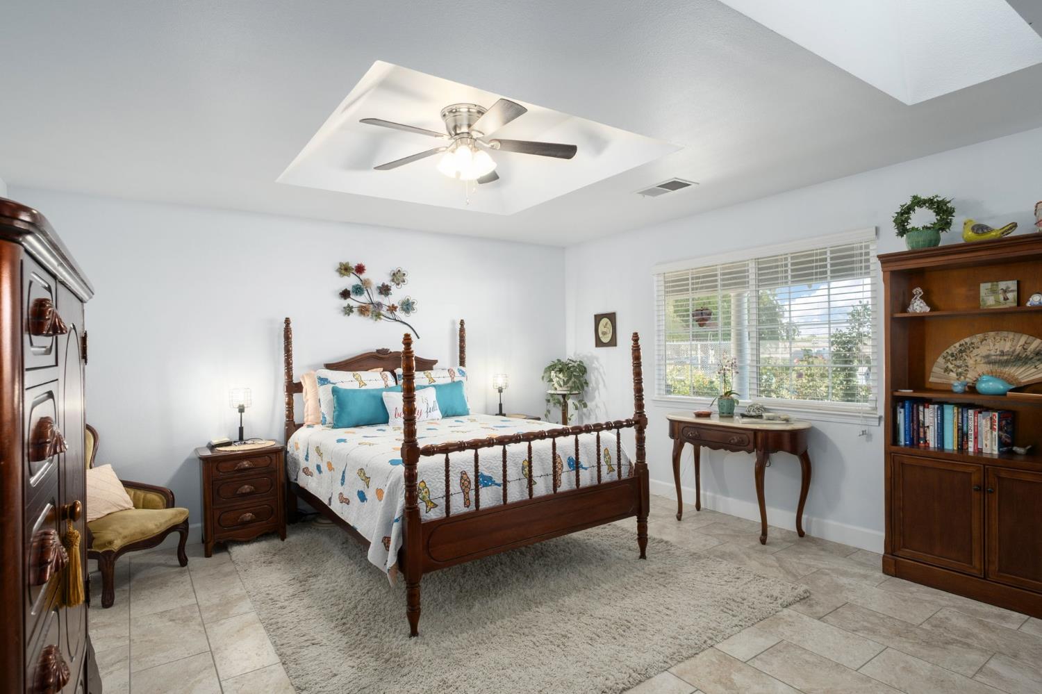 17534 West Lacey Boulevard Lemoore, CA 93245 - Photo 30 of 49 a bedroom with a bed and a chandelier