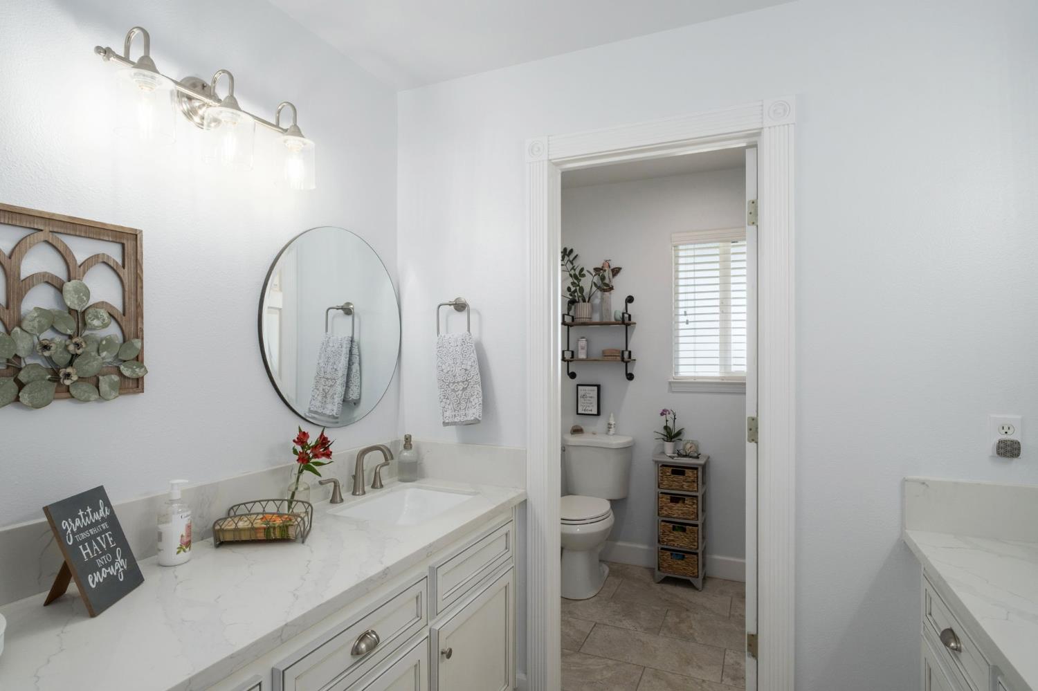 17534 West Lacey Boulevard Lemoore, CA 93245 - Photo 34 of 49 a bathroom with a sink and a mirror
