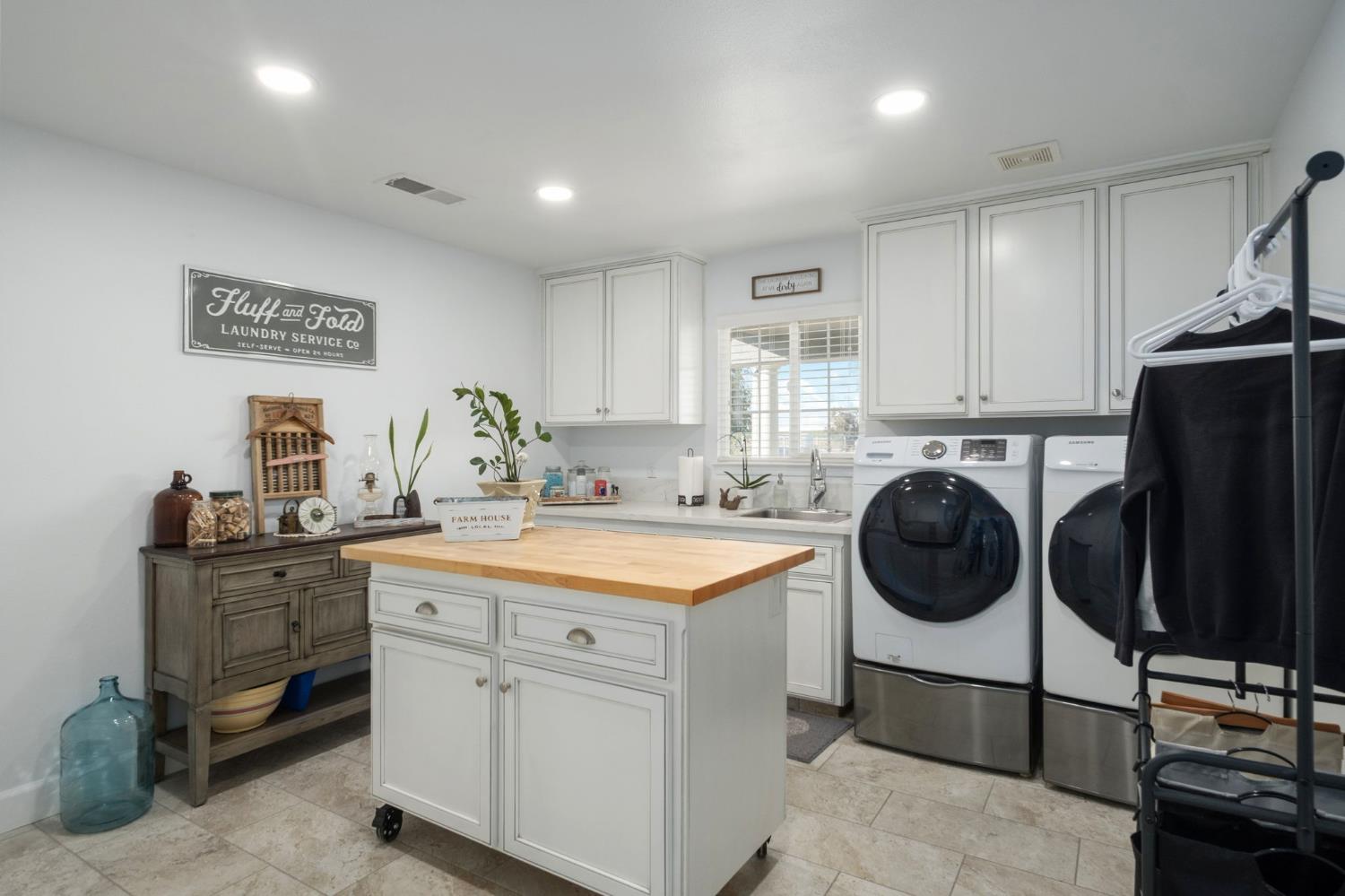 17534 West Lacey Boulevard Lemoore, CA 93245 - Photo 36 of 49 a kitchen that has a sink and a stove