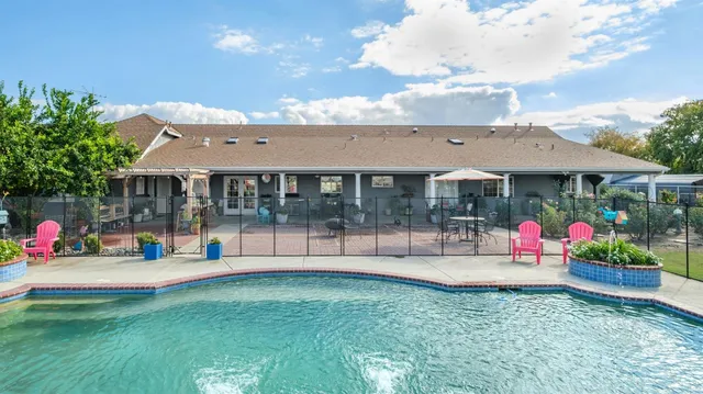 a view of a house with a yard and sitting area