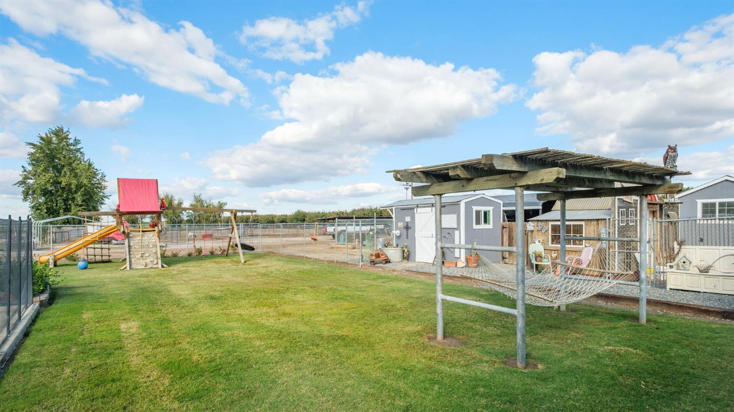 17534 West Lacey Boulevard Lemoore, CA 93245 - Photo 42 of 49 a view of a house with a yard and sitting area