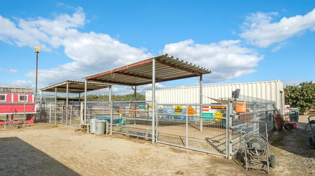 a view of roof deck with chair and tables