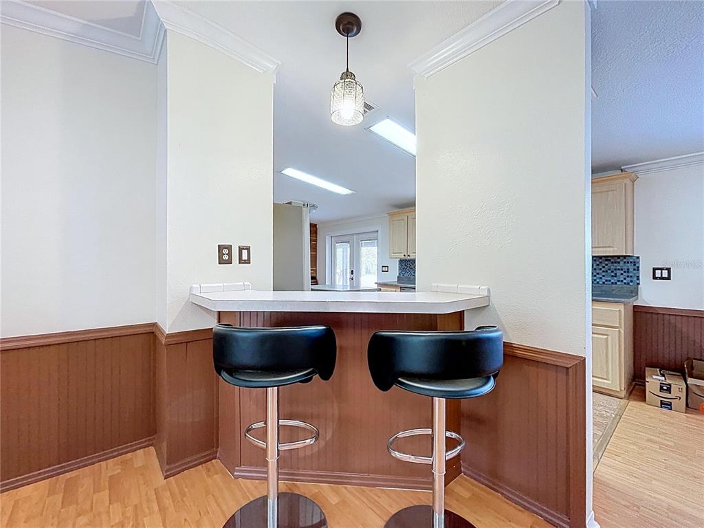 15210 Rough Diamond Ranch Road Lithia, FL 33547 - Photo 36 of 76 a view of a dining room with furniture and wooden floor