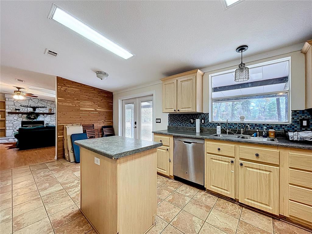 15210 Rough Diamond Ranch Road Lithia, FL 33547 - Photo 40 of 76 a kitchen with granite countertop cabinets a sink a counter top space and stainless steel appliances
