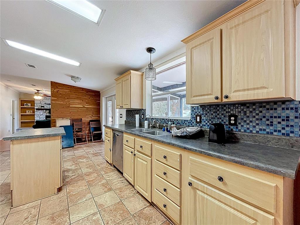15210 Rough Diamond Ranch Road Lithia, FL 33547 - Photo 43 of 76 a kitchen with stainless steel appliances a sink window and cabinets