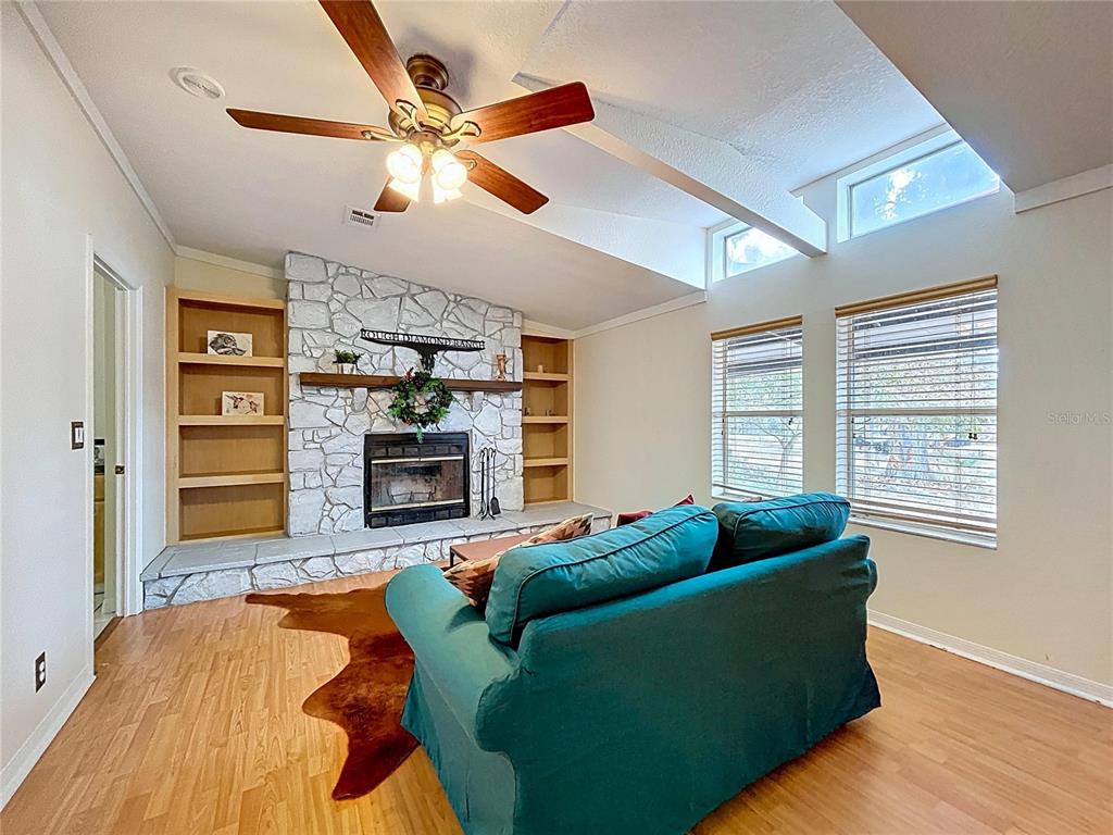 15210 Rough Diamond Ranch Road Lithia, FL 33547 - Photo 46 of 76 a living room with furniture and a fireplace