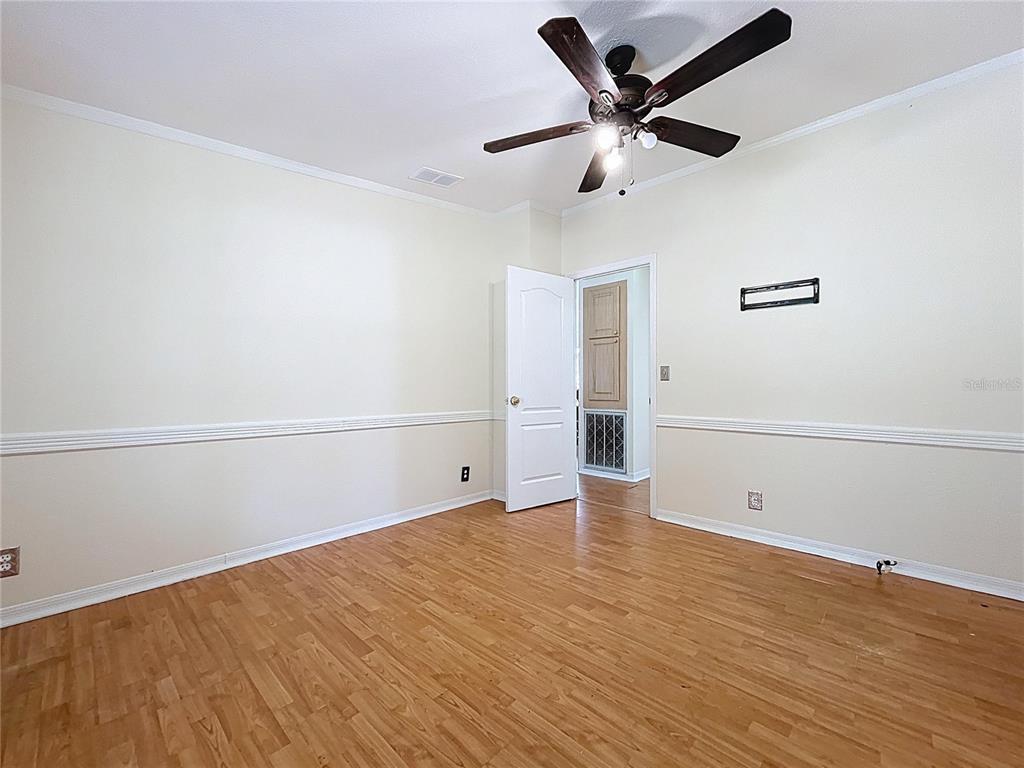 15210 Rough Diamond Ranch Road Lithia, FL 33547 - Photo 54 of 76 an empty room with wooden floor and windows