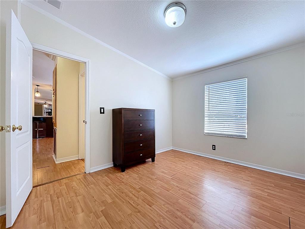 15210 Rough Diamond Ranch Road Lithia, FL 33547 - Photo 58 of 76 a view of an empty room with wooden floor and a window