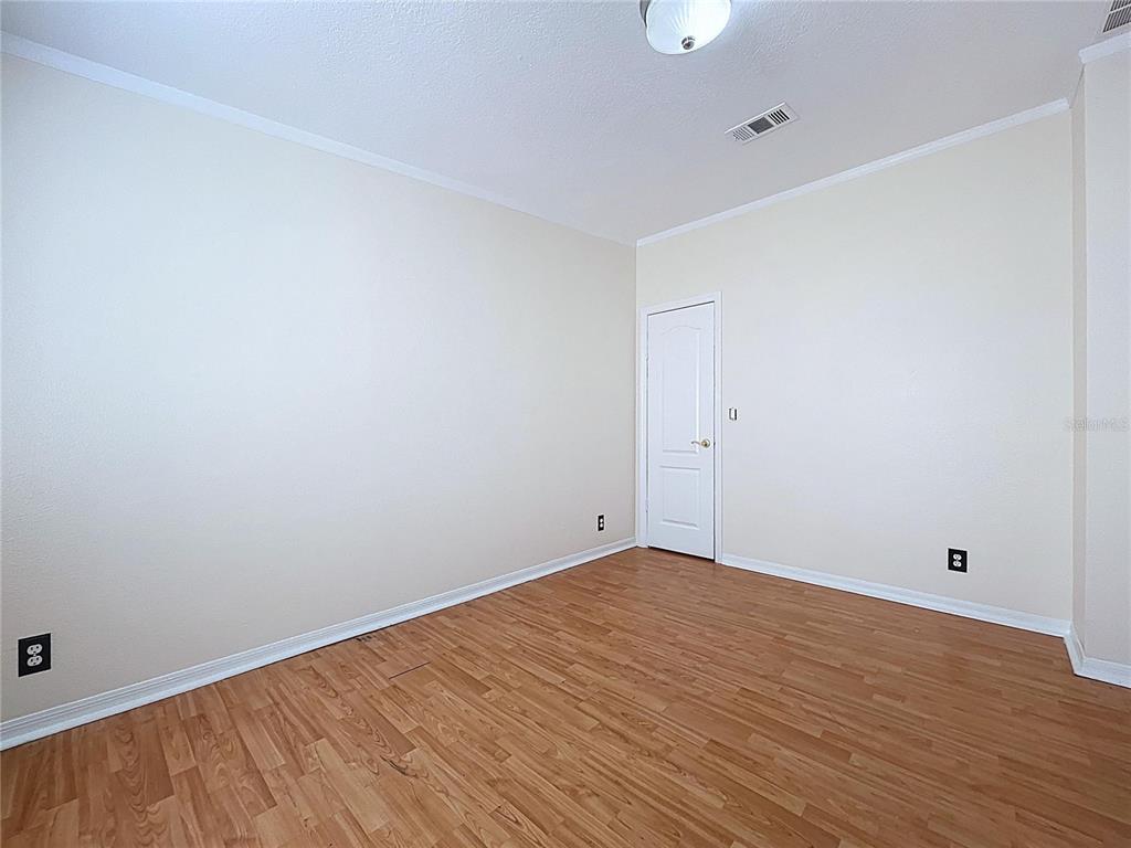 15210 Rough Diamond Ranch Road Lithia, FL 33547 - Photo 62 of 76 a view of an empty room with wooden floor