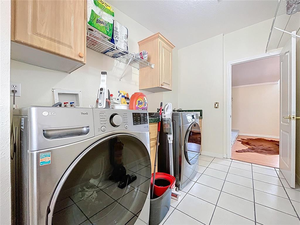 15210 Rough Diamond Ranch Road Lithia, FL 33547 - Photo 69 of 76 a utility room with dryer and washer