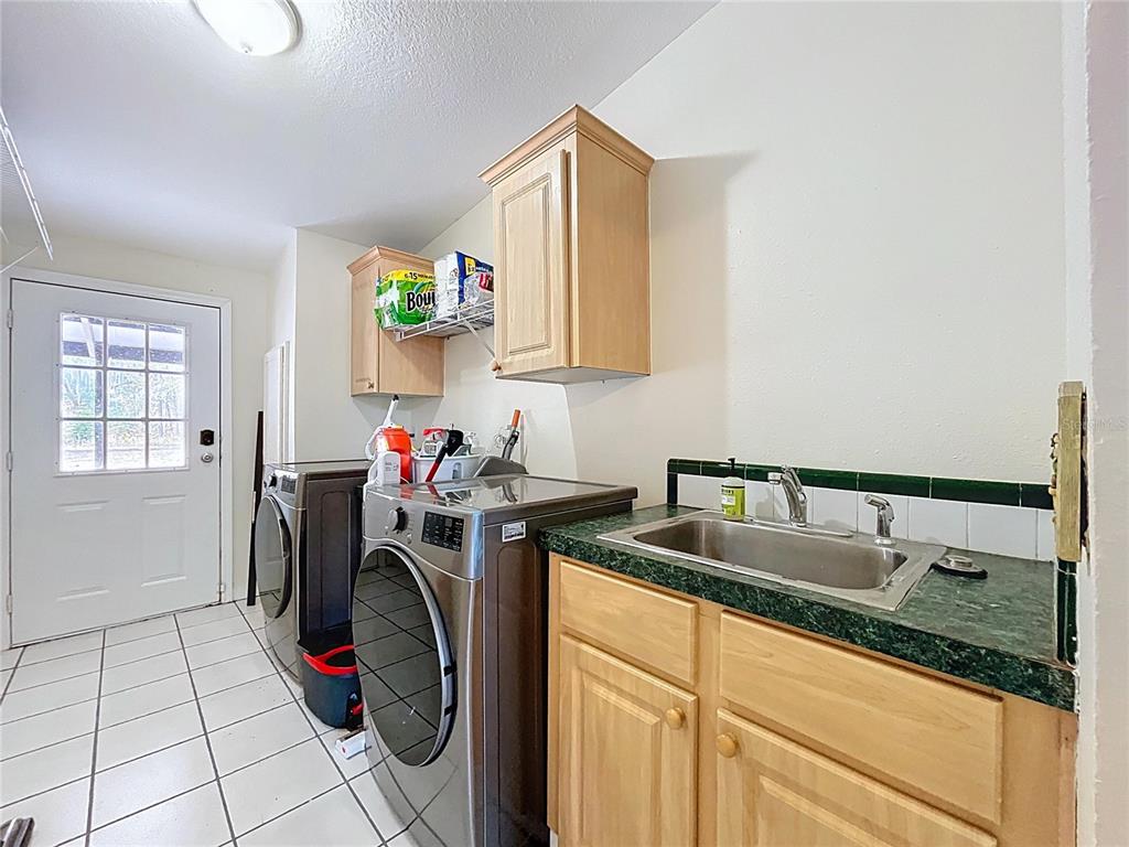 15210 Rough Diamond Ranch Road Lithia, FL 33547 - Photo 70 of 76 a utility room with sink dryer and washer