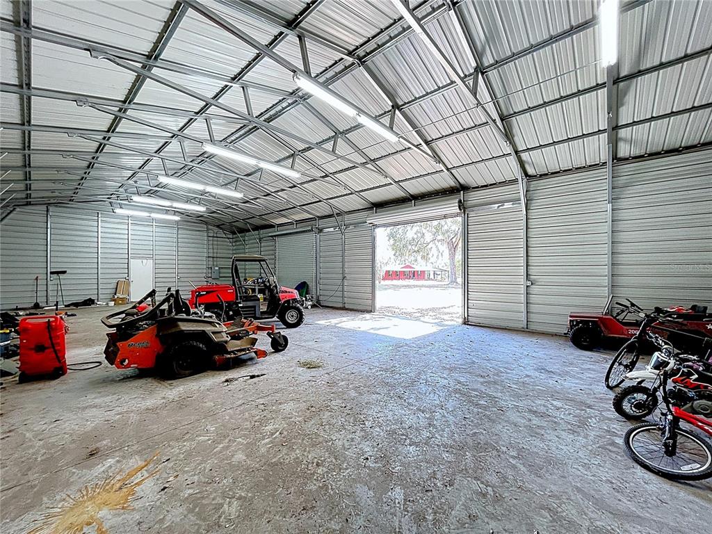 15210 Rough Diamond Ranch Road Lithia, FL 33547 - Photo 9 of 76 a view of a garage with a bike and wooden walls
