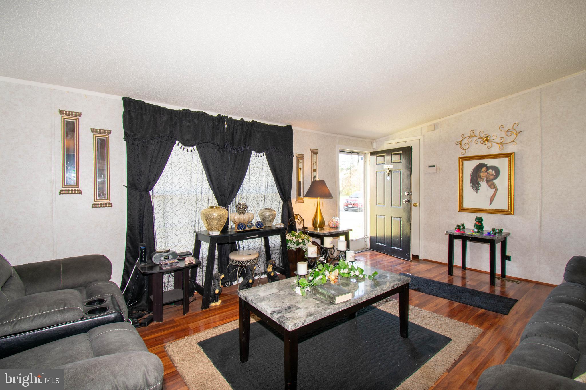 8791 Menokin Road Montross, VA 22520 - Photo 11 of 37 a living room with furniture a rug and a table
