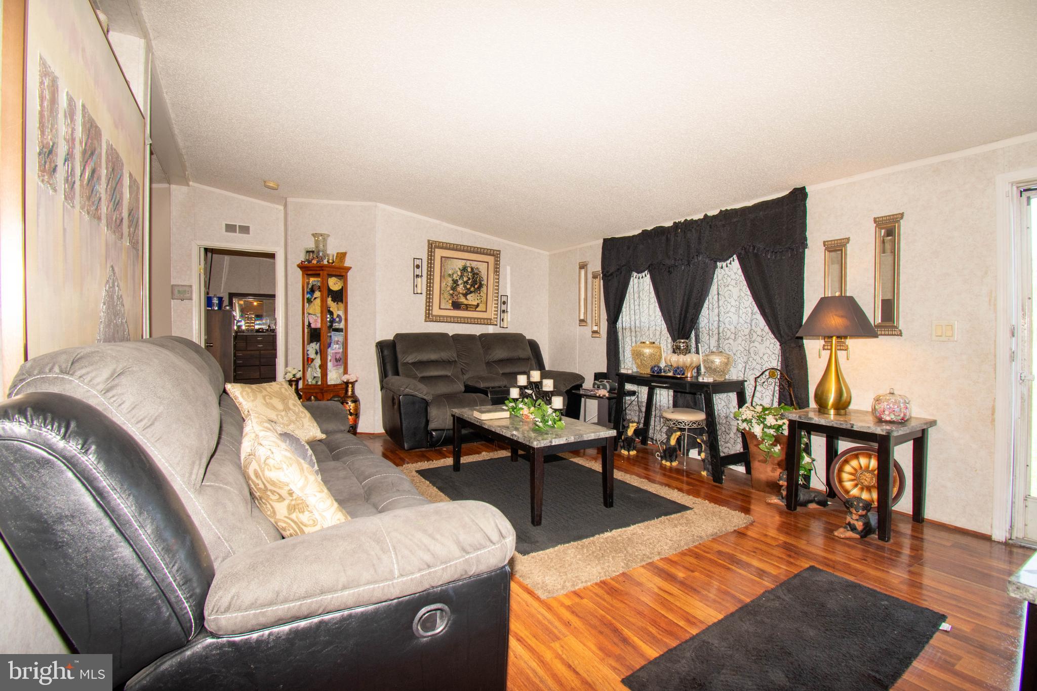 8791 Menokin Road Montross, VA 22520 - Photo 14 of 37 a living room with furniture a rug and a large window