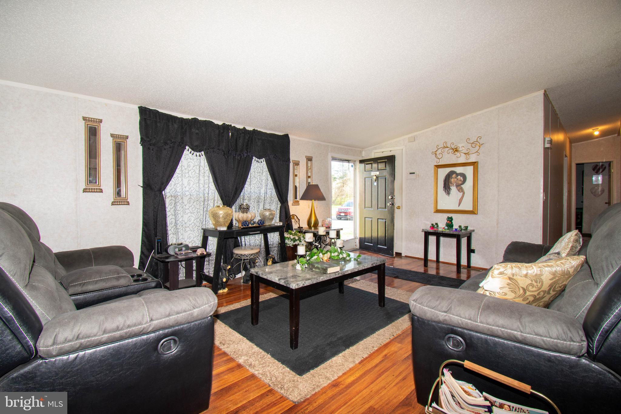 8791 Menokin Road Montross, VA 22520 - Photo 15 of 37 a living room with furniture and a wooden floor