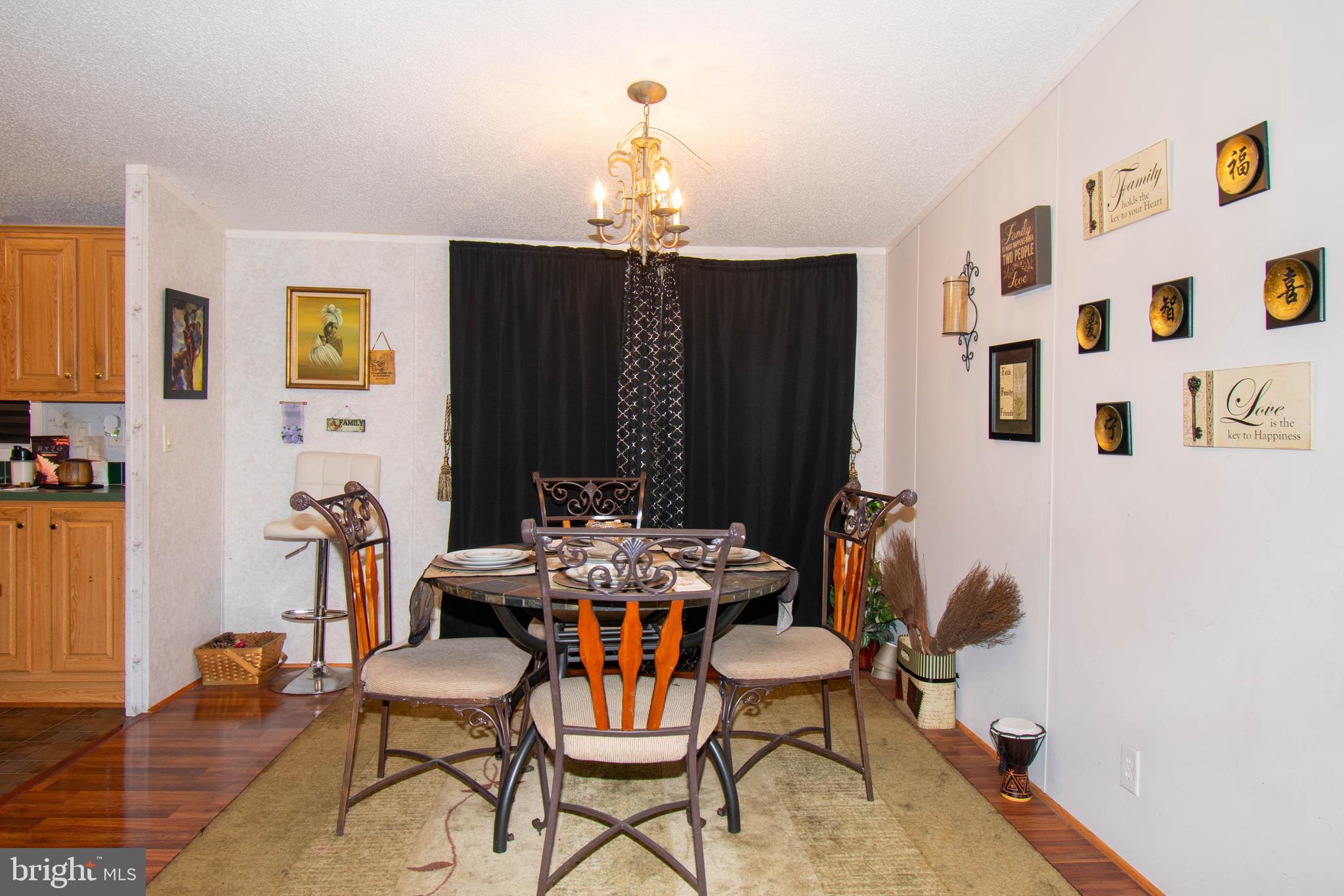 8791 Menokin Road Montross, VA 22520 - Photo 16 of 37 a view of a dining room with furniture and chandelier