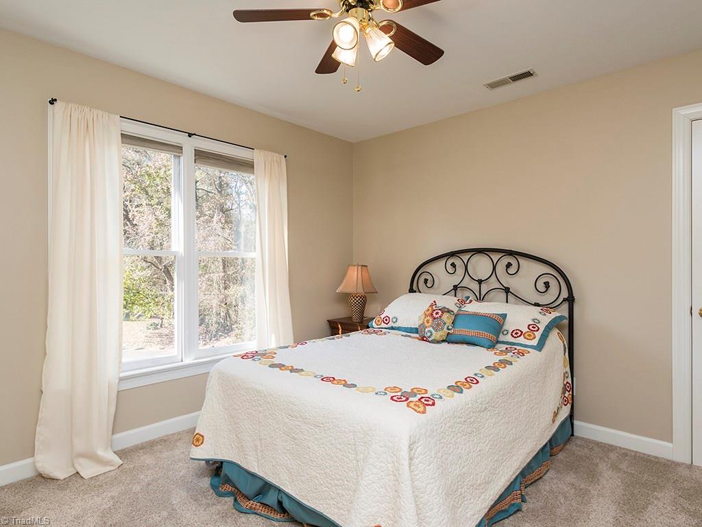 3101 Spring Mill Road Greensboro, NC 27406 - Photo 17 of 30 Bedroom two! Great light from the window, ceiling fan and closet with hinge door, so you are not messing with a bifold door!