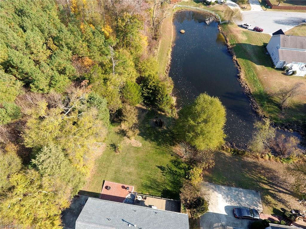 3101 Spring Mill Road Greensboro, NC 27406 - Photo 27 of 30 Gives you a look at just how much backyard you have to play with between your deck and the pond. As well as the privacy secondary to the landscaping of your neighbor (your only close neighbor) to the right.