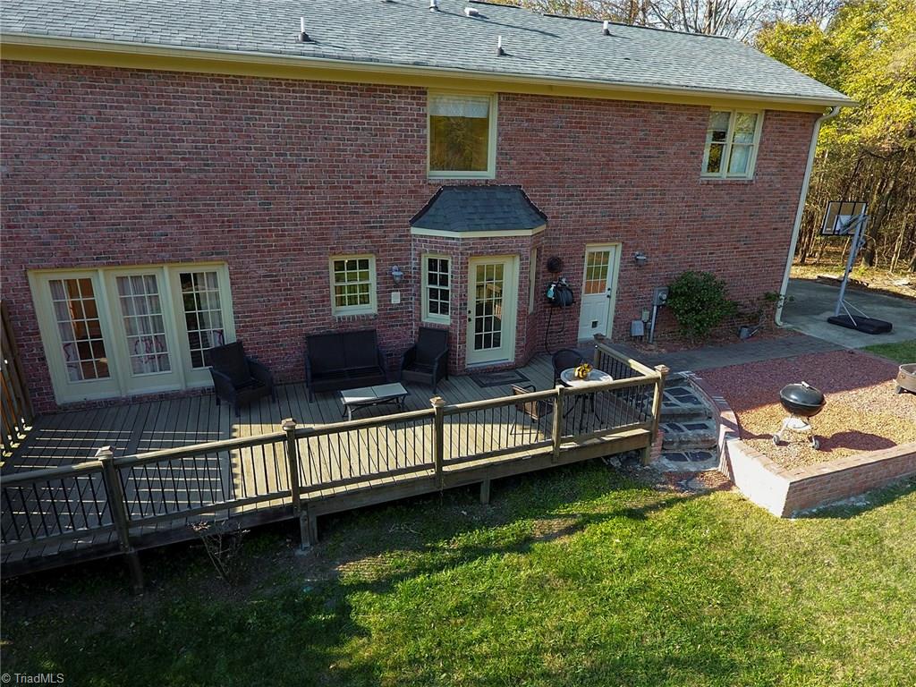 3101 Spring Mill Road Greensboro, NC 27406 - Photo 28 of 30 Shows off layout of deck, doors to deck, and firepit area.