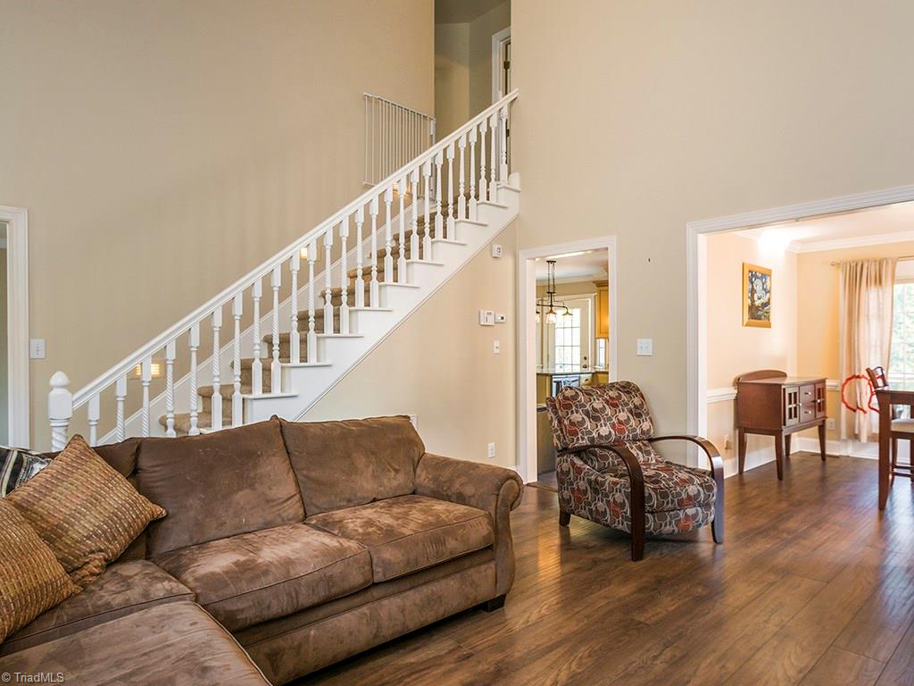 3101 Spring Mill Road Greensboro, NC 27406 - Photo 7 of 30 Can really get a feel for how tall this ceiling is in this shot and how open the layout is from dining to living room.