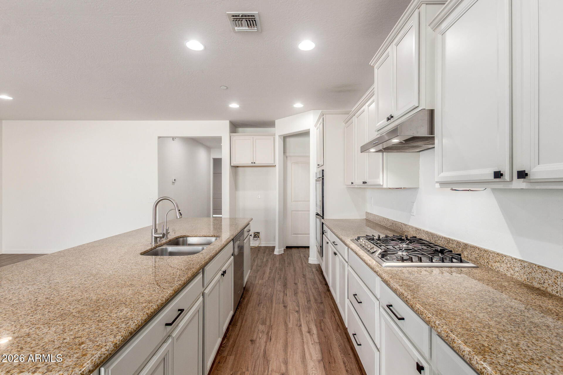 21294 West Berkeley Road Buckeye, AZ 85396 - Photo 11 of 34 a kitchen with stainless steel appliances granite countertop a sink stove and refrigerator