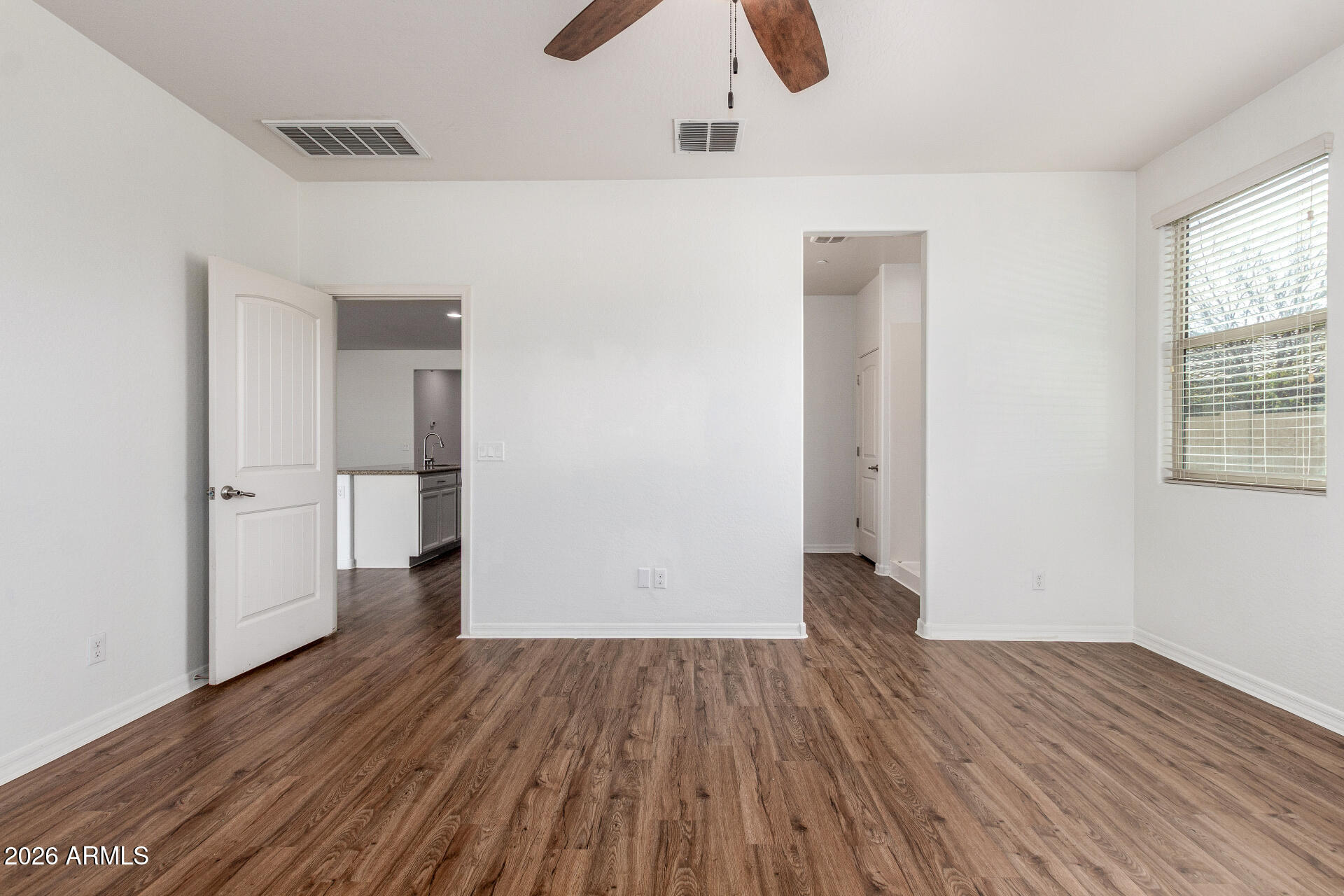 21294 West Berkeley Road Buckeye, AZ 85396 - Photo 14 of 34 an empty room with wooden floor and windows