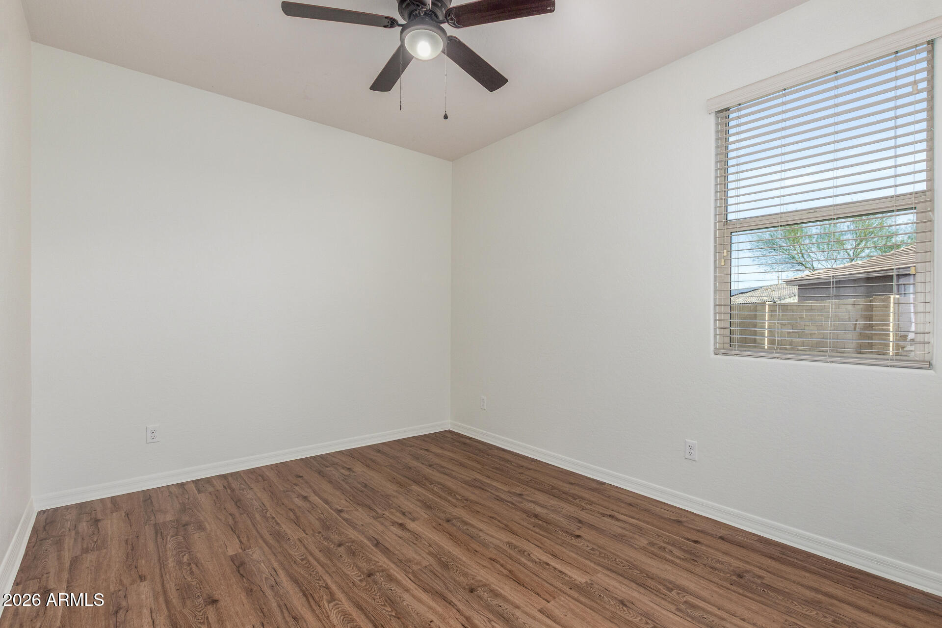 21294 West Berkeley Road Buckeye, AZ 85396 - Photo 21 of 34 a view of a room with wooden floor and windows