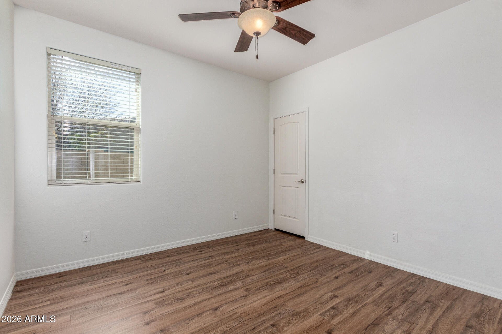 21294 West Berkeley Road Buckeye, AZ 85396 - Photo 24 of 34 a view of a room with wooden floor and windows
