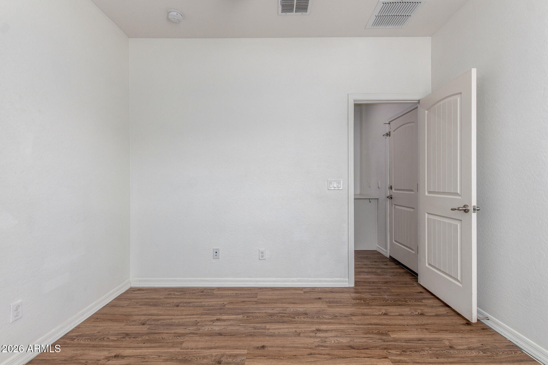 21294 West Berkeley Road Buckeye, AZ 85396 - Photo 25 of 34 a view of a room with wooden floor