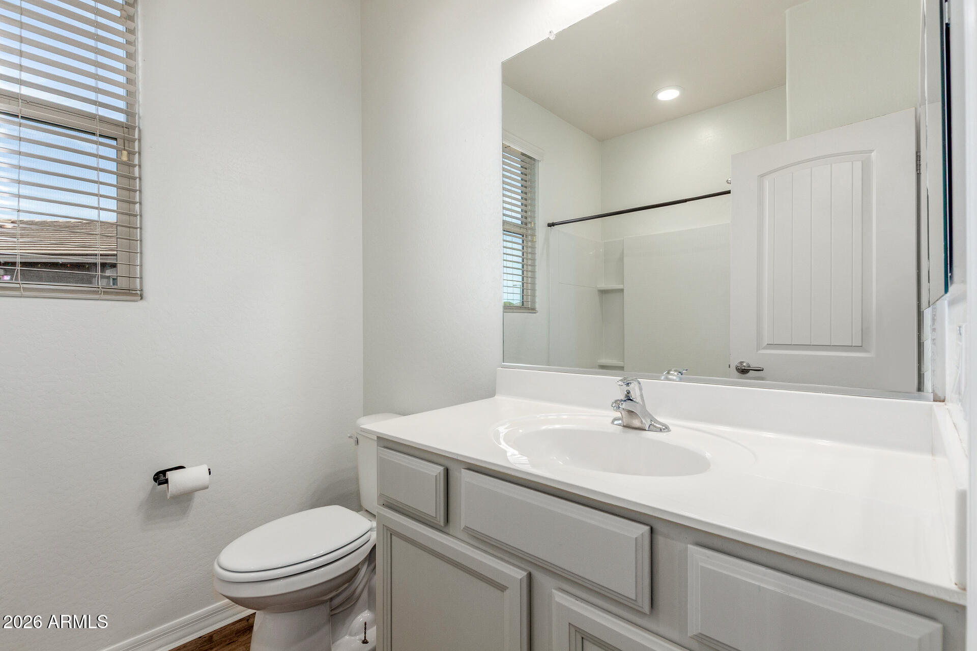 21294 West Berkeley Road Buckeye, AZ 85396 - Photo 26 of 34 a bathroom with a sink toilet and a mirror