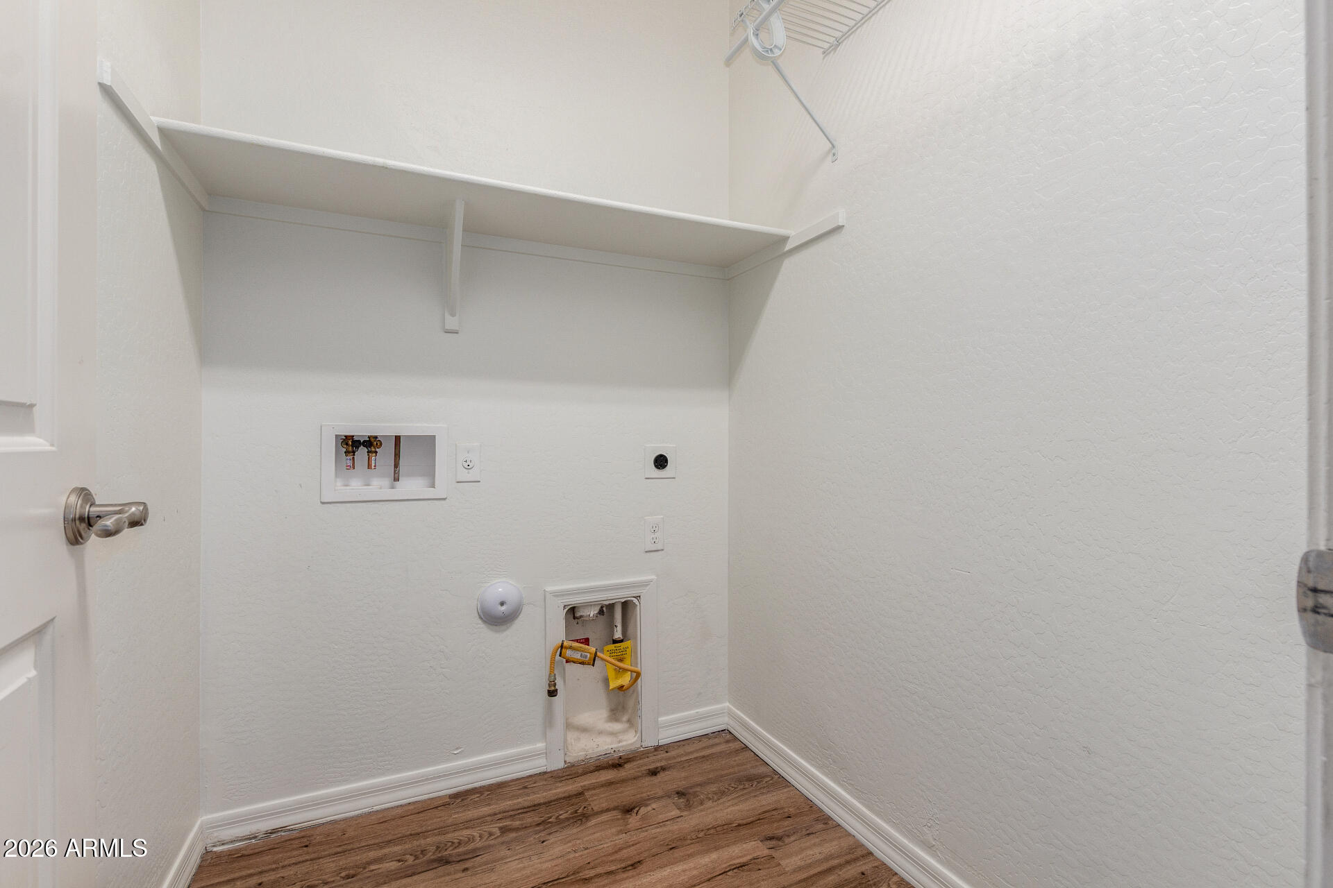 21294 West Berkeley Road Buckeye, AZ 85396 - Photo 28 of 34 a view of storage and utility room with wooden floor