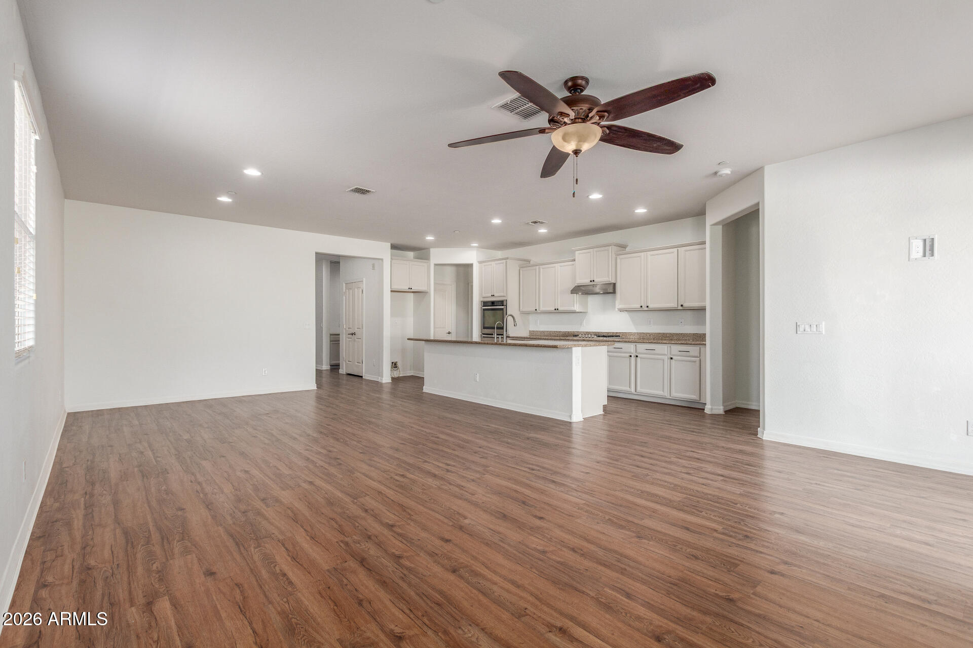 21294 West Berkeley Road Buckeye, AZ 85396 - Photo 3 of 34 a view of a kitchen with a sink and wooden floor