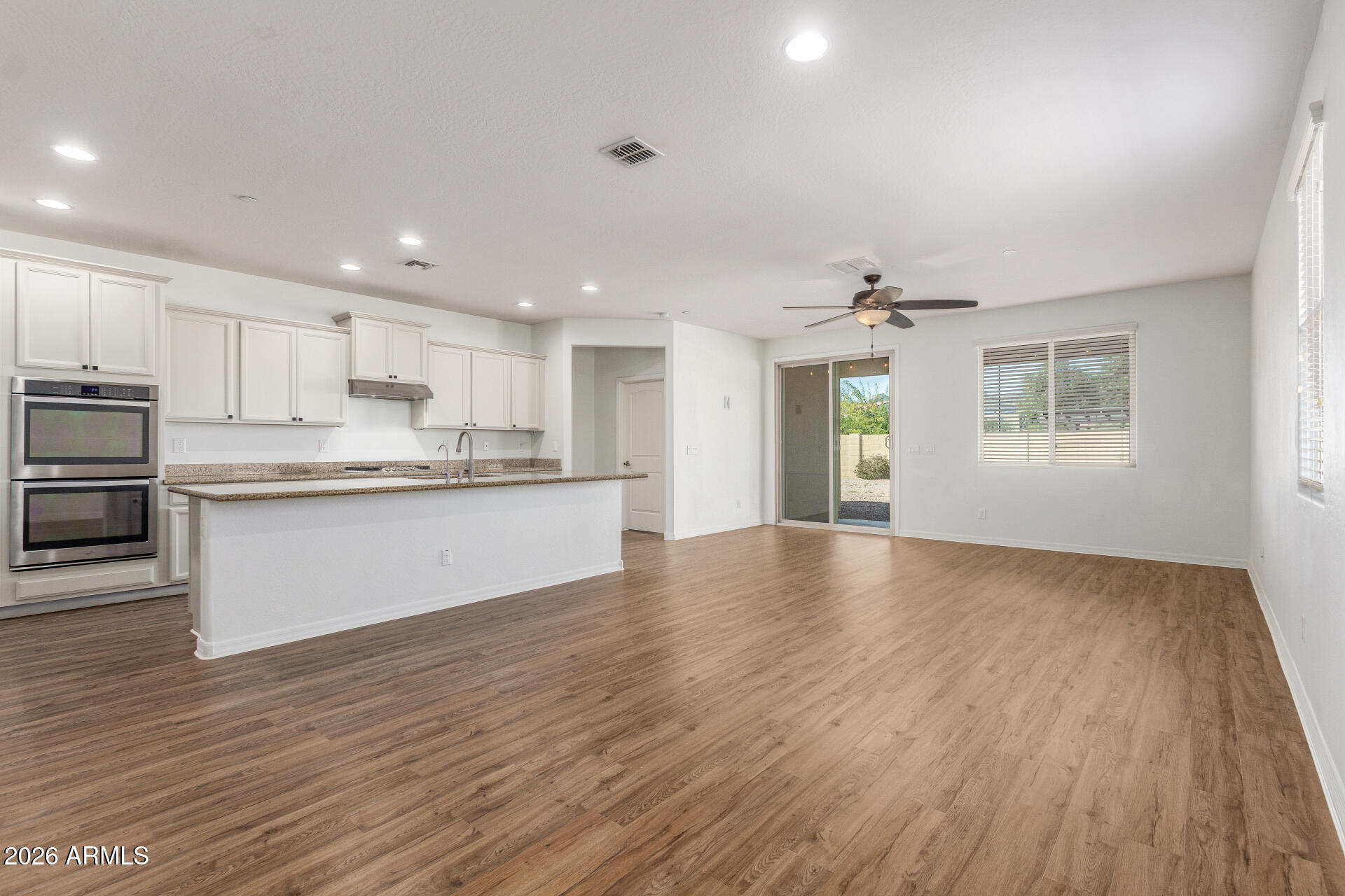 21294 West Berkeley Road Buckeye, AZ 85396 - Photo 6 of 34 a view of kitchen with wooden floor and electronic appliances