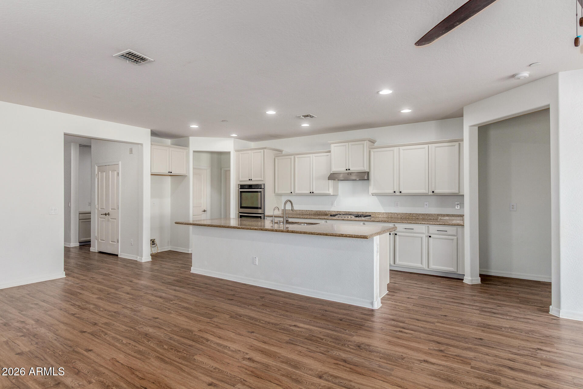 21294 West Berkeley Road Buckeye, AZ 85396 - Photo 9 of 34 a large kitchen with granite countertop a large counter top stainless steel appliances and cabinets
