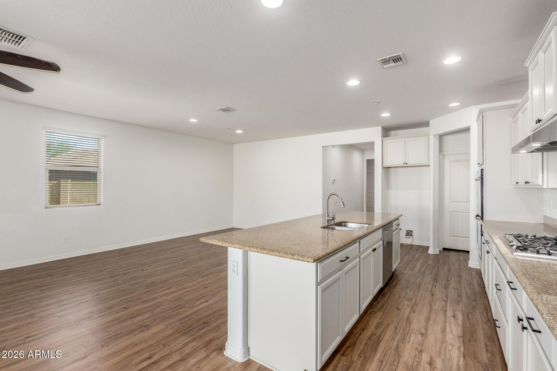 21294 West Berkeley Road Buckeye, AZ 85396 - Photo 10 of 34 a kitchen with a sink stove and refrigerator