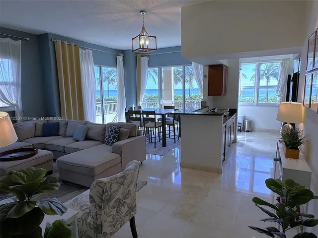 a living room with furniture potted plant a window and a flat screen tv